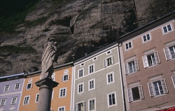 AUSTRIA, Salzburg, Pastel coloured houses on Gstatiengasse built into the Monchsberg beneath the