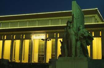 CHINA, Beijing, Tiananmen Square.  Mausoleum of Mao Zedong illuminated at night with statue in