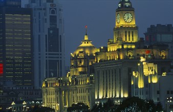 CHINA, Shanghai, The Bund at night with skyscrapers and the Customs House illuminated.