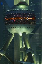 CHINA, Shanghai, Part view of the Oriental Pearl Tower exterior illuminated at night.