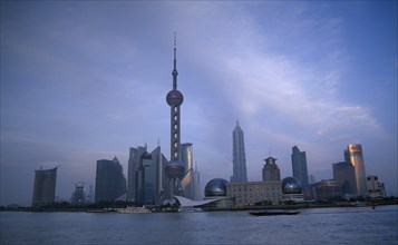 CHINA, Shanghai, Pudong skyline at dusk with skyscrapers including the Oriental Pearl Tower and the
