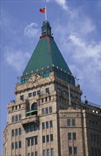 CHINA, Shanghai, The Peace Hotel on the Bund.  Detail of exterior tower with green rooftop and