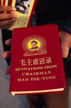 CHINA, Beijing, "Tiananmen Square.  Person holding copy of Mao Tse-Tung’s ‘Little Red Book’ of
