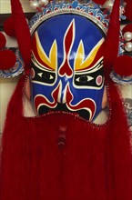 CHINA, Beijing, "Huguang Guildhall.  Bright red, blue, yellow and black opera mask."