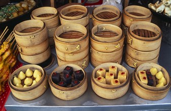 CHINA, Beijing, Donghua Yeshi food market.  Display of bamboo steamers of sweetmeats.