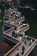 CHINA, Shanghai, "Yu Gardens.  View over zig-zag foot-bridge over pond with mass of silver and