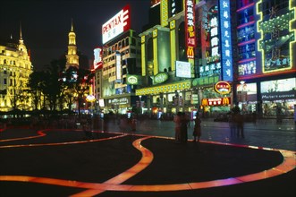 CHINA, Shanghai, "Nanjing Lu.  Busy street scene at night with illuminated shop fronts, neon signs