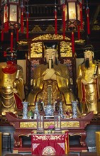 CHINA, Shanghai, "Yu Gardens, Temple of the City of God.  Three golden statues behind small altar