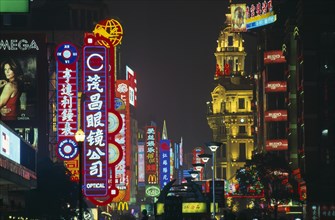 CHINA, Shanghai, Nanjing Lu.  Street scene at night with mass of illuminated neon signs and