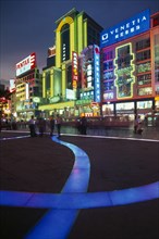 CHINA, Shanghai, Nanjing Lu.  Busy street scene at night with illuminated neon signs and
