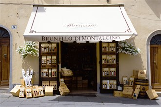 ITALY, Tuscany, Montalcino, Wine shop in the medieval hilltown with a display of wines on the