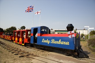 ENGLAND, West Sussex, Littlehampton, Families enjoying a miniature railway ride in Norfolk Gardens