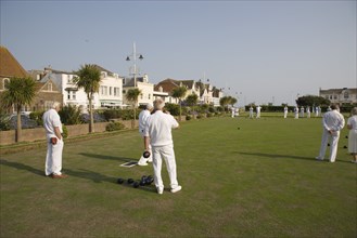 ENGLAND, West Sussex, Bognor Regis, Men playing a game of bowls on green