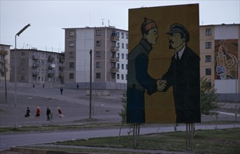 MONGOLIA, Ulan Bator, Soviet billboard in central Ulan Bator  depicting Lenin shaking hands with