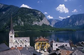 AUSTRIA, Oberosterreich, Hallstatt, "View over tiled village rooftops, hotel and church with lake