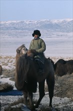 MONGOLIA, Gobi Desert, "Young Khalkha man dressed in traditional fleece-lined winter clothing on