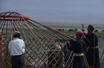 MONGOLIA, Gobi Desert, Bigersum  Freedom negdel collective  Khalkha herdsmen building a ger or yurt