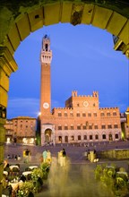 ITALY, Tuscany, Siena, "Early evening in the Piazza del Campo seen through an archway with people