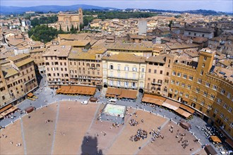 ITALY, Tuscany, Siena, View over the Piazza del Campo and the north of the city. People walk in the