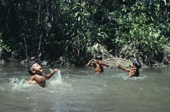 COLOMBIA, North West Amazon, Tukano Indigenous People, Three young Makuna children playing in water
