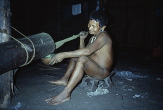 COLOMBIA, North West Amazon, Tukano Indigenous People, "Visiting Maku nomadic hunter pounding coca
