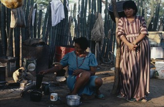 COLOMBIA, Guajira Peninsula, Guajiro Indians, Guajira Indian desert settlement  Two women in