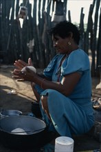 COLOMBIA, Guajira Peninsula, Guajiro Indians, "Guajira Indian woman in the process of making