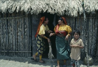 PANAMA, San Blas Islands Tikantiki , Kuna Indians, Kuna Indian women wearing brightly coloured