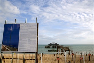ENGLAND, East Sussex, Brighton, Ruins of the West pier with boards showing plans for the i360