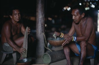 COLOMBIA, North West Amazon, Tukano Indigenous People, Makuna headman Ignacio taking powdered coca
