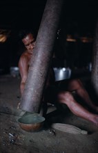 COLOMBIA, North West Amazon, Tukano Indigenous People, Makuna man emptying pounded powdered coca