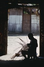 COLOMBIA, North West Amazon, Tukano Indigenous People, Makuna head man Ignacio making cane basket