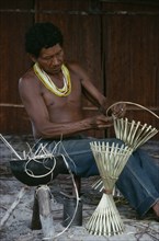 COLOMBIA, North West Amazon, Tukano Indigenous People, Makuna man making cane cooking pot stands.