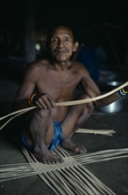 COLOMBIA, North West Amazon, Tukano Indigenous People, Makuna head man Ignacio starting to make a