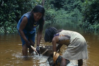 COLOMBIA, North West Amazon, Tukano Indigenous People, Makuna mother and daughter washing manioc