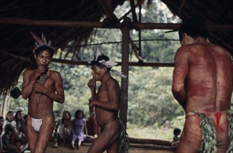 COLOMBIA, North West Amazon, Vaupes, Maku men taking part in dance and playing pan-pipes watched by