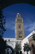 MOROCCO, Casablanca, Main Mosque in Habbous District. Minaret seen from under an arch