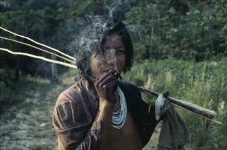 COLOMBIA, North West Amazon, Tukano Indigenous People, Barasana Indian smoking home grown tobacco