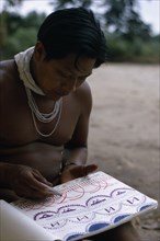 COLOMBIA, North West Amazon, Tukano Indigenous People, Young Barasana shaman Pacico draws for