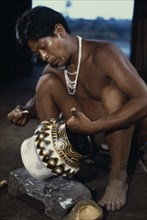 COLOMBIA, North West Amazon, Tukano Indigenous People, "Barasana tribesman painting white,yellow