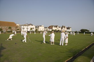ENGLAND, West Sussex, Bognor Regis, Men and women playing a game of bowls on beach front green