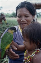 COLOMBIA, North West Amazon, Tukano Indigenous People, Makuna mother and child with pet parrot.