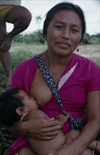 COLOMBIA, North West Amazon, Tukano Indigenous People, Makuna mother breastfeeding baby. Tukano