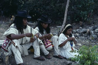 COLOMBIA, Sierra Nevada de Santa Marta, Ika, Ika  children of the Chaparro family beside grave of