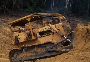 BRAZIL, Mato Grosso, Peixoto de Azevedo, "Bulldozer opening road through deforested area,now a