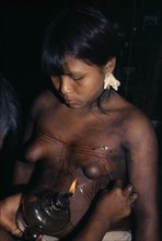 COLOMBIA, Choco, Embera Indigenous People, Young Embera daughters with sweet-smelling lilies in