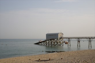 ENGLAND, West Sussex, Selsey, Royal National Lifeboat Institution. View across shingle beach