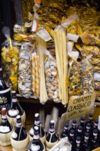 ITALY, Tuscany, San Gimignano, Shop display of a variety of colourful pastas and Chianti wines