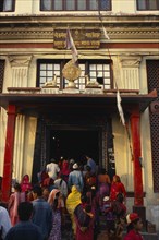 NEPAL, Kathmandhu Valley, Swayambhunath, Buddhist pilgrims at temple stupa entrance.