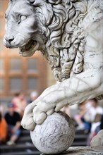 ITALY, Tuscany, Florence, "Sculpture of a lion with its paw on a cannon ball at the entrance to the